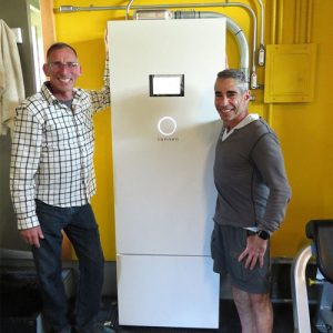 Satisfied Synergy Solar customers standing with their sonnenBatterie solar backup system