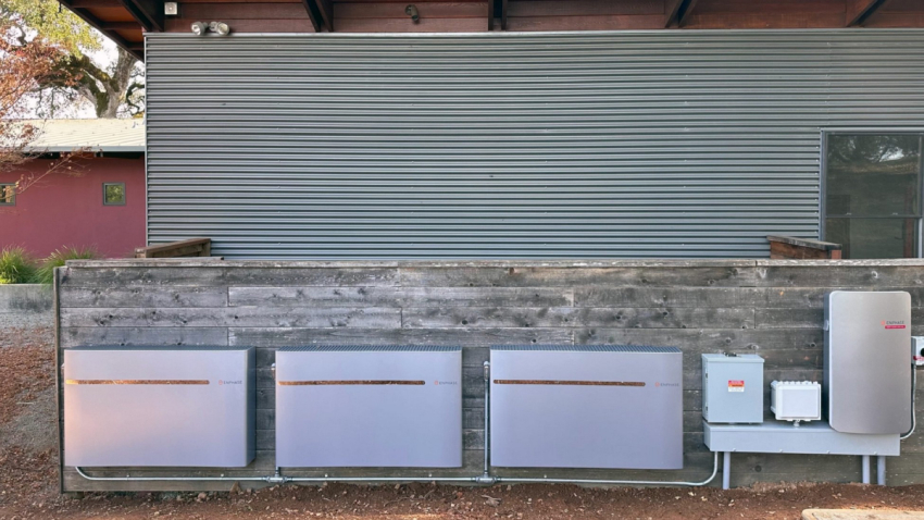 A large home backup battery installed on a wall.